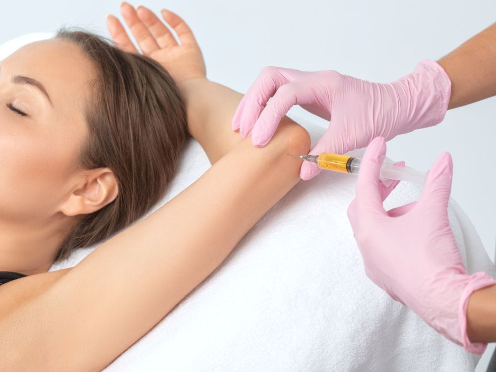 A doctor administering stem cell therapy to a patient.