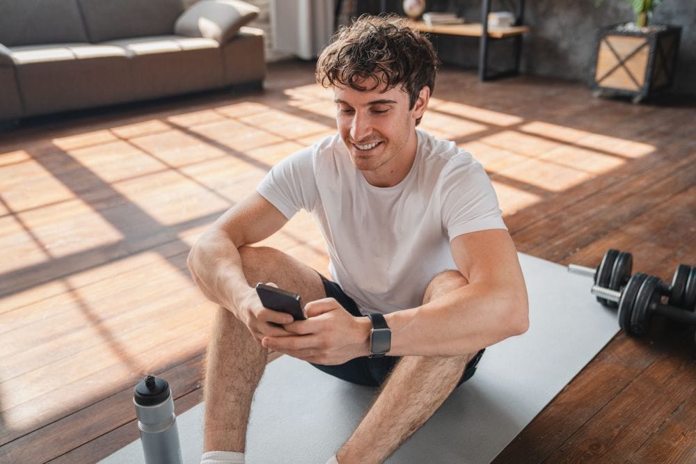 A male athlete reading about Peptides for recovery and muscle growth.