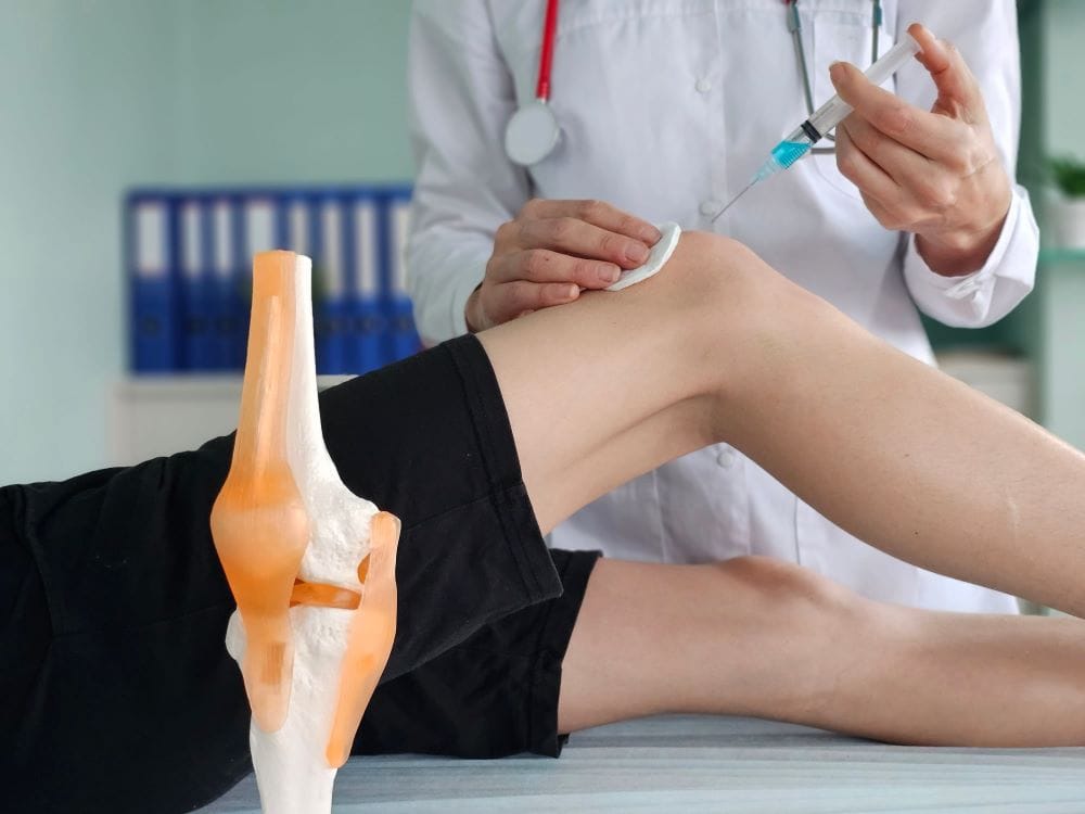 A physician administers an allogeneic cell therapy protocol to a patient’s knee.