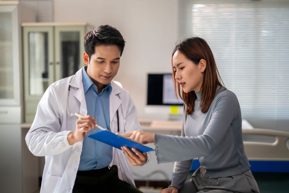 A physician reviewing biomarker results with a patient in a longevity medicine consultation.